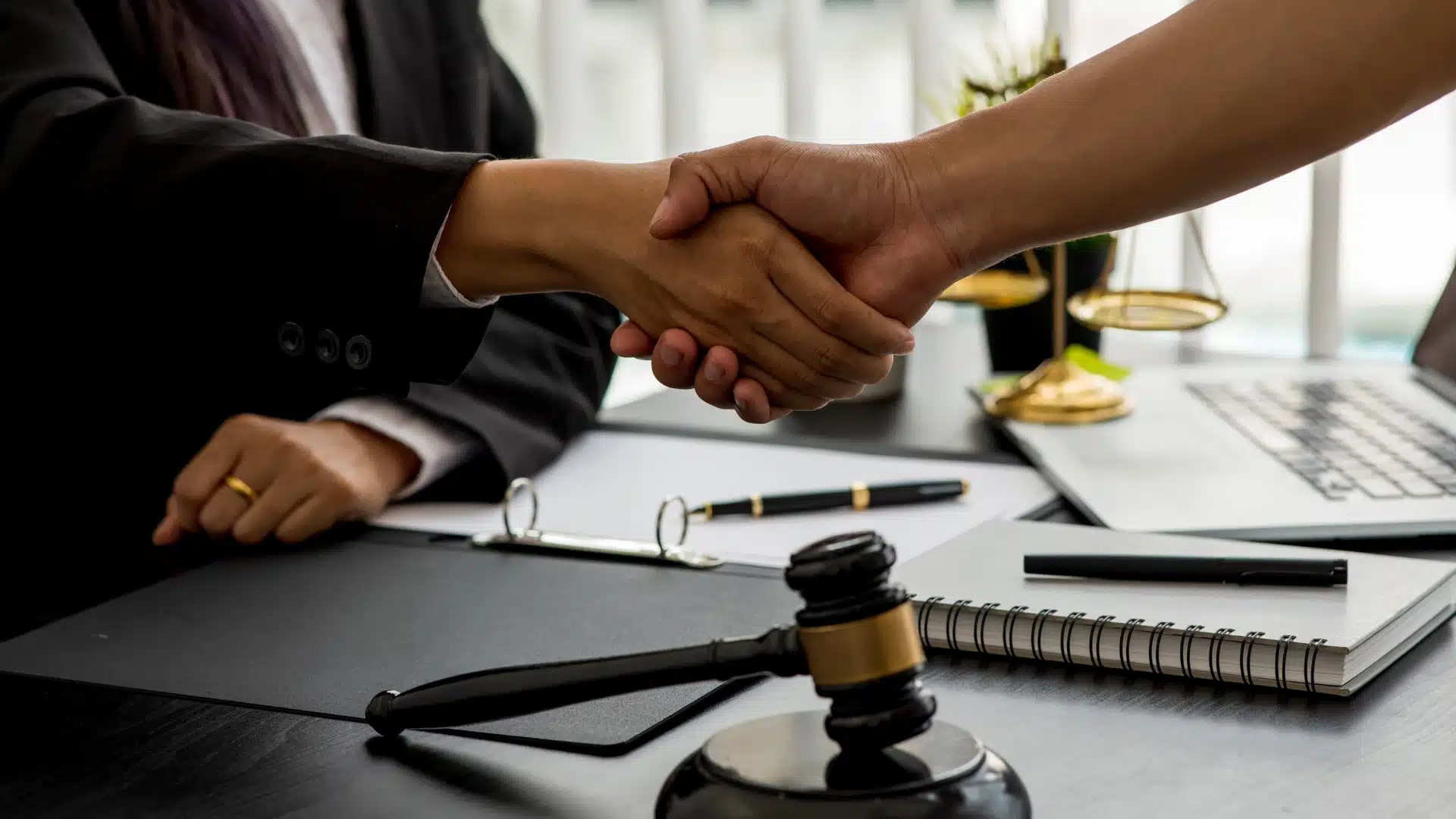 Lawyer shaking hands with client after consultation.