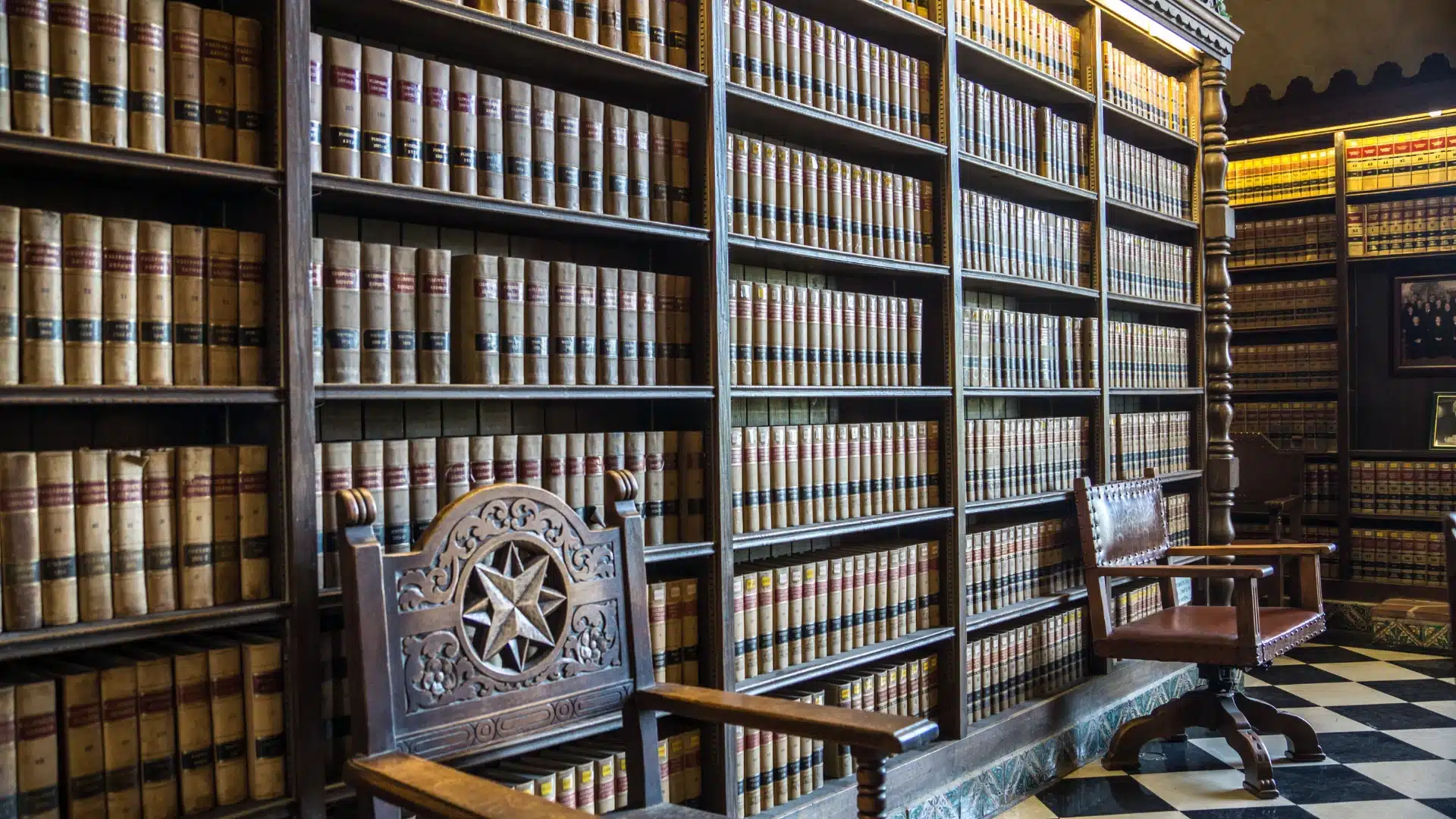 Law library with shelves of legal volumes and a carved wooden chair.