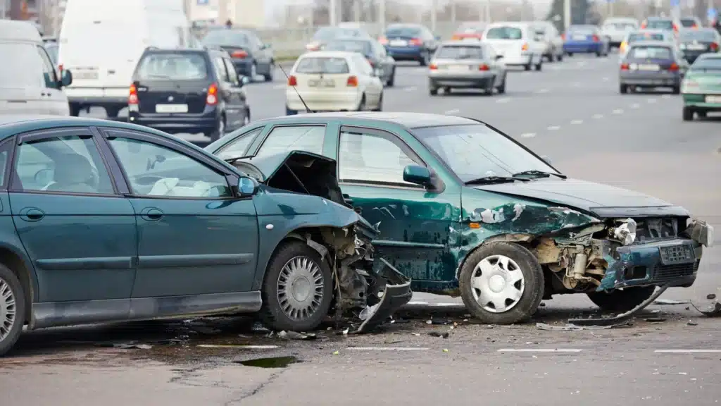 Two cars involved in a severe collision with visible front-end damage.