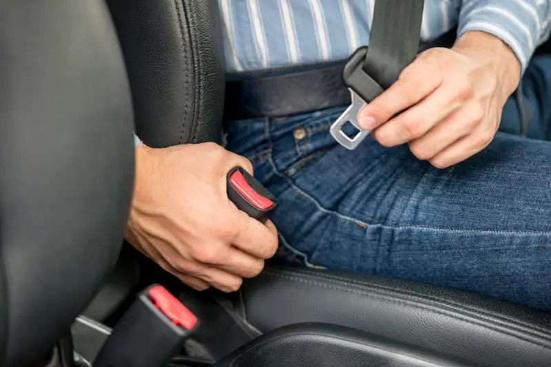 Attorney reviewing car accident case involving belt retractor defect and faulty seatbelt injury claim.