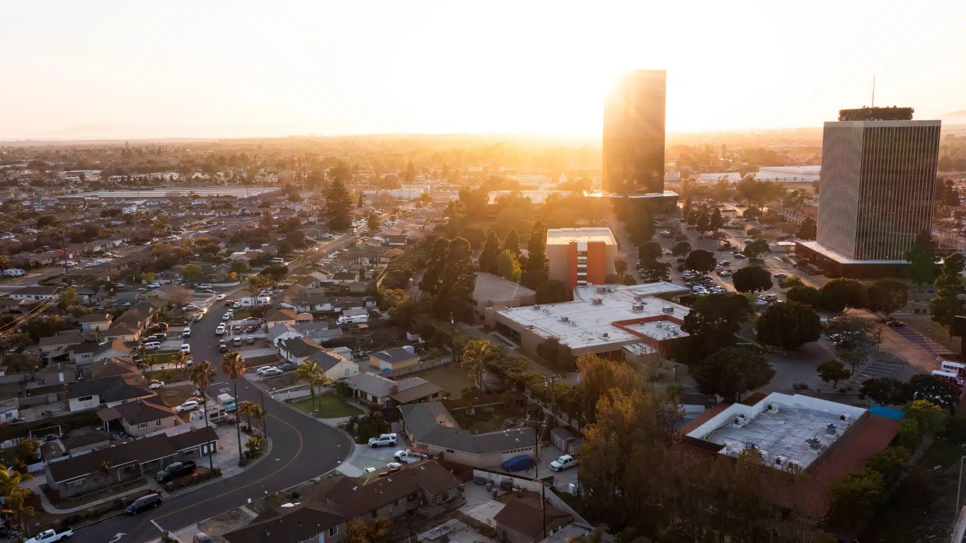 Aerial view of Oxnard, California at sunset showing city streets, homes, and skyline